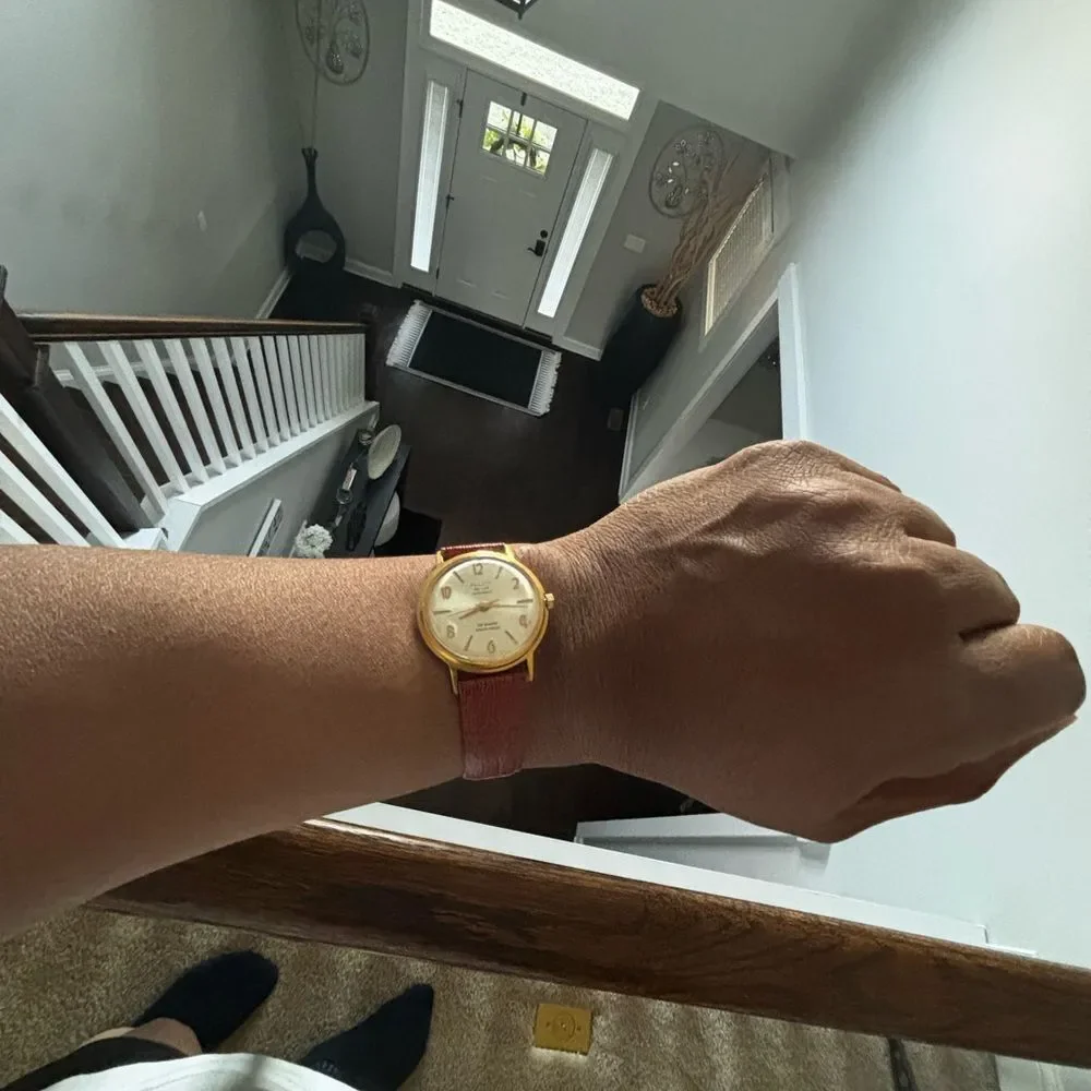 Elegant Gold Watch with Brown Leather Strap
